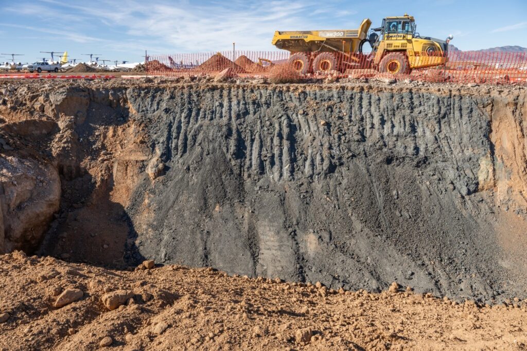 Dump truck next to excavated dross pit. Completed project won ACEC Arizona Award.